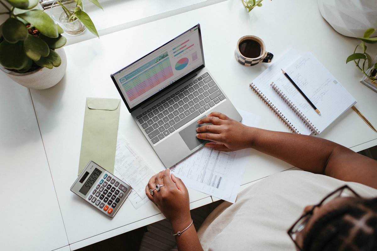 A small business owner reviewing technology and financial tools on a laptop